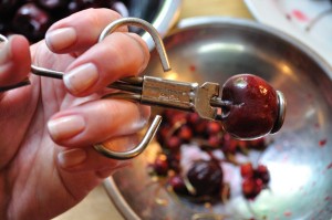 Cherry loaded into pitter - Food Gypsy
