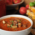 Rustic Creamy Tomato Soup with toasted croutons, chilies & basil.
